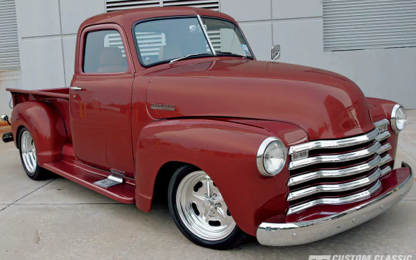 A deep red 1947 Chevrolet pickup truck with polished chrome and classic design, captured in high definition for a PC desktop wallpaper background.