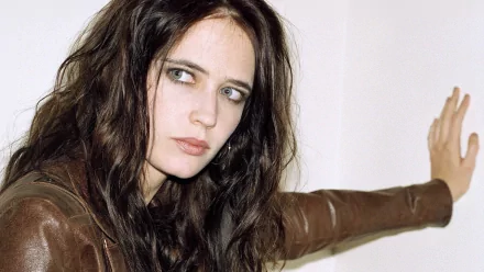Eva Green poses thoughtfully, showcasing her striking features and dark, tousled hair. This HD image serves as an eye-catching desktop wallpaper or background.