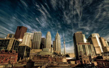 HD desktop wallpaper showcasing Toronto’s man-made skyline in Canada with dramatic cloud formations above the city’s iconic buildings and the CN Tower.