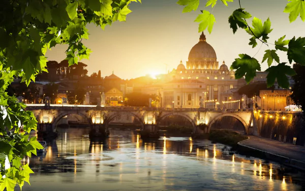 A stunning HD wallpaper featuring a sunset over the Tiber River in Rome, highlighting the beautiful architecture and bridges, framed by lush green leaves.