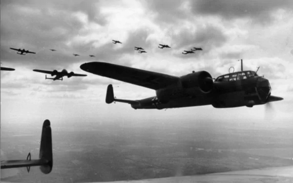 Black and white HD desktop wallpaper showing a formation of military Dornier Do 17 aircraft flying above the clouds.