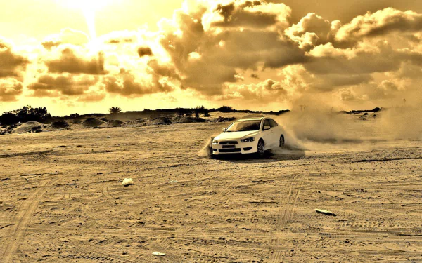 HD PC desktop wallpaper background: Mitsubishi Motors vehicle drifting across sandy terrain, kicking up dust under dramatic golden clouds.