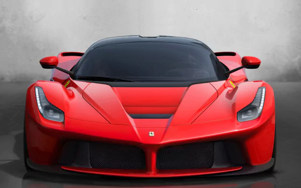 HD PC desktop wallpaper featuring a striking red Ferrari Geneve sports car viewed from the front with sleek design details and bold headlights.
