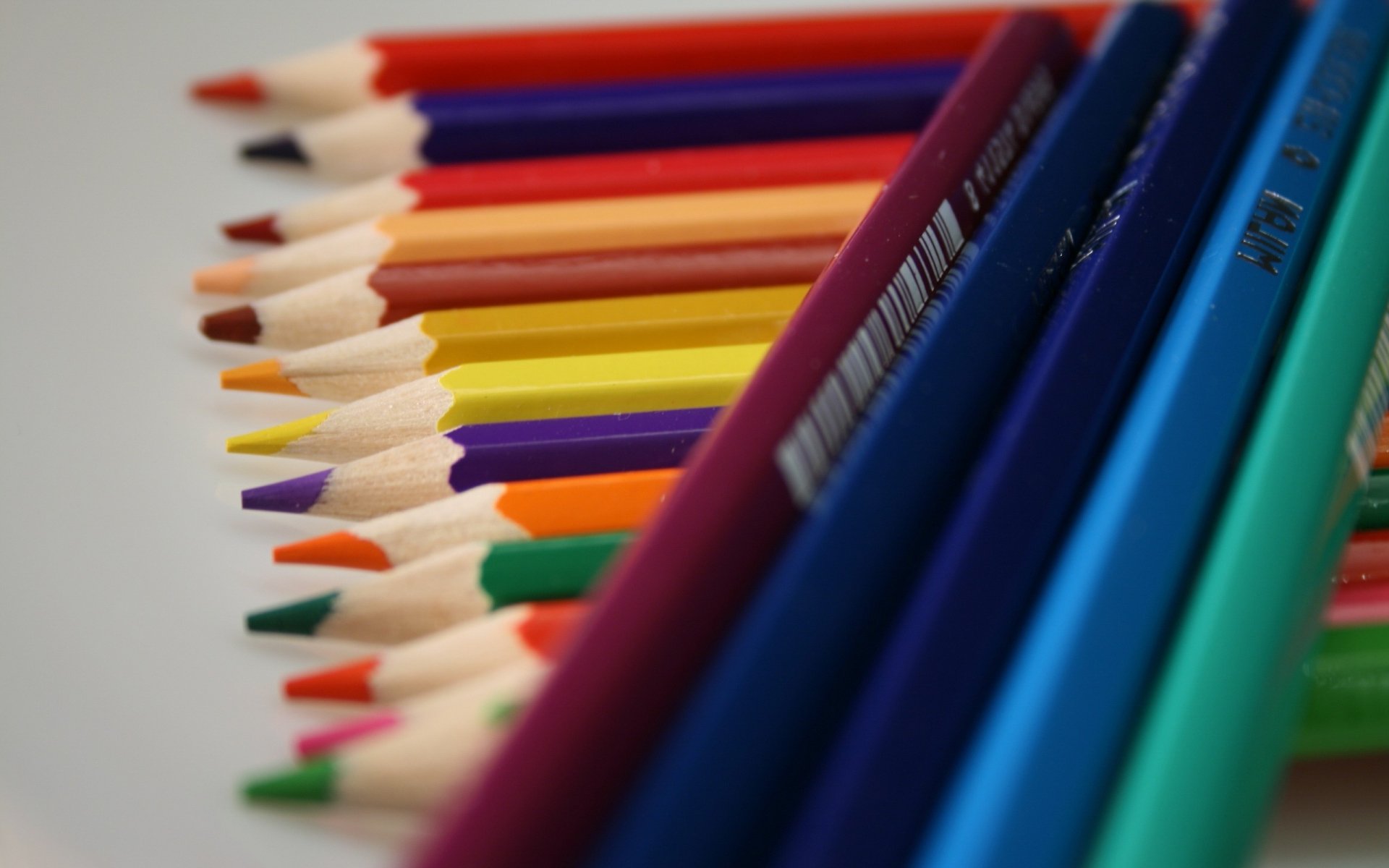 Close-up photography of colorful sharpened pencils fanned diagonally — 2K Quad HD PC desktop wallpaper and background.