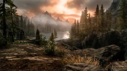HD desktop wallpaper from The Elder Scrolls V: Skyrim featuring a serene landscape with a misty lake, forests and mountains bathed in sunset light.