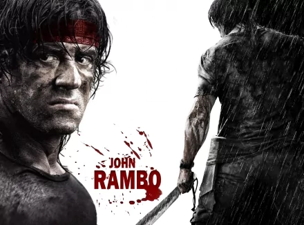 HD desktop wallpaper featuring a gritty image of Rambo in action with the text John Rambo in red, set against a rain-soaked background.