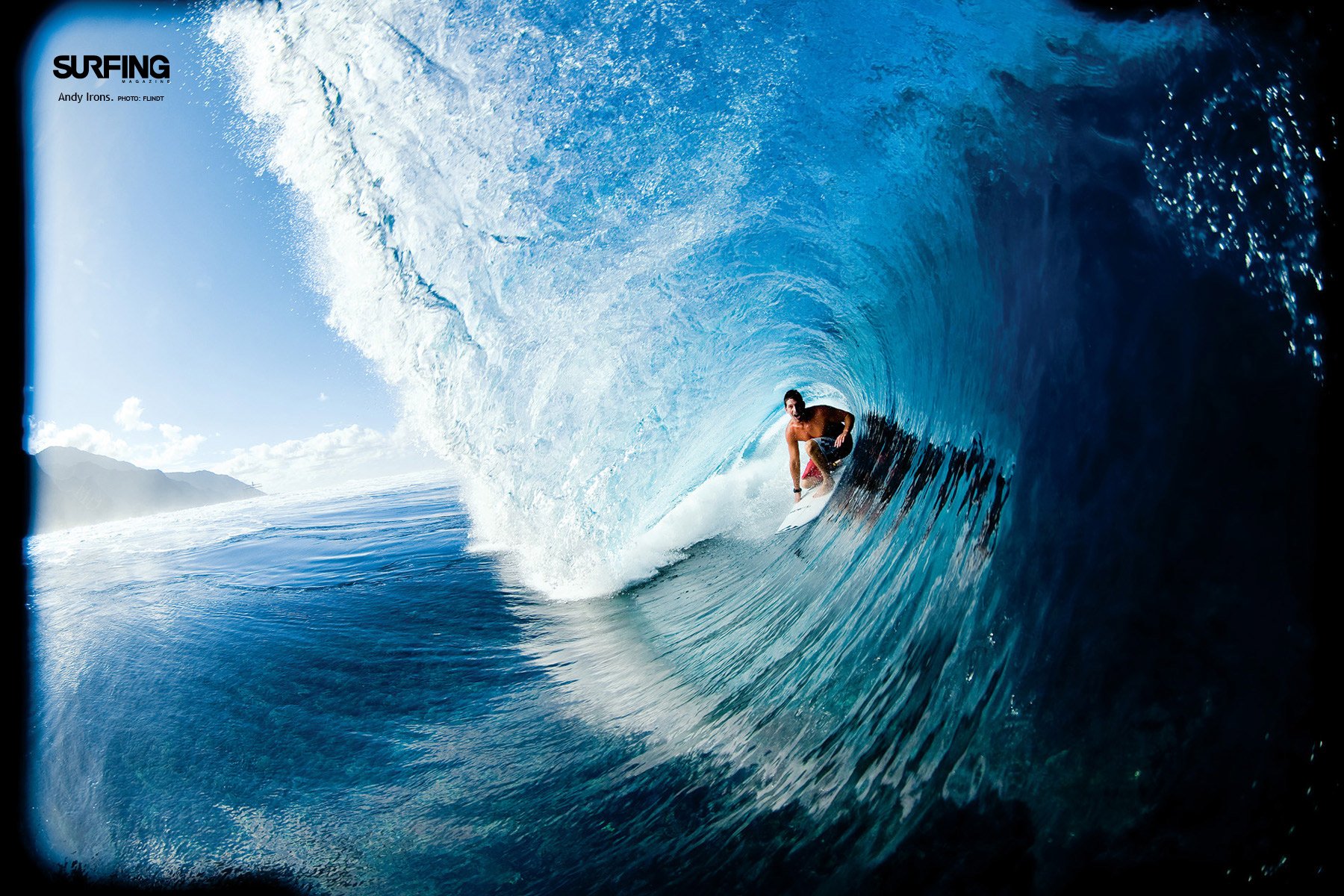 HD PC desktop wallpaper featuring a surfer riding inside a large, curling blue ocean wave, capturing the thrill and intensity of the sport.