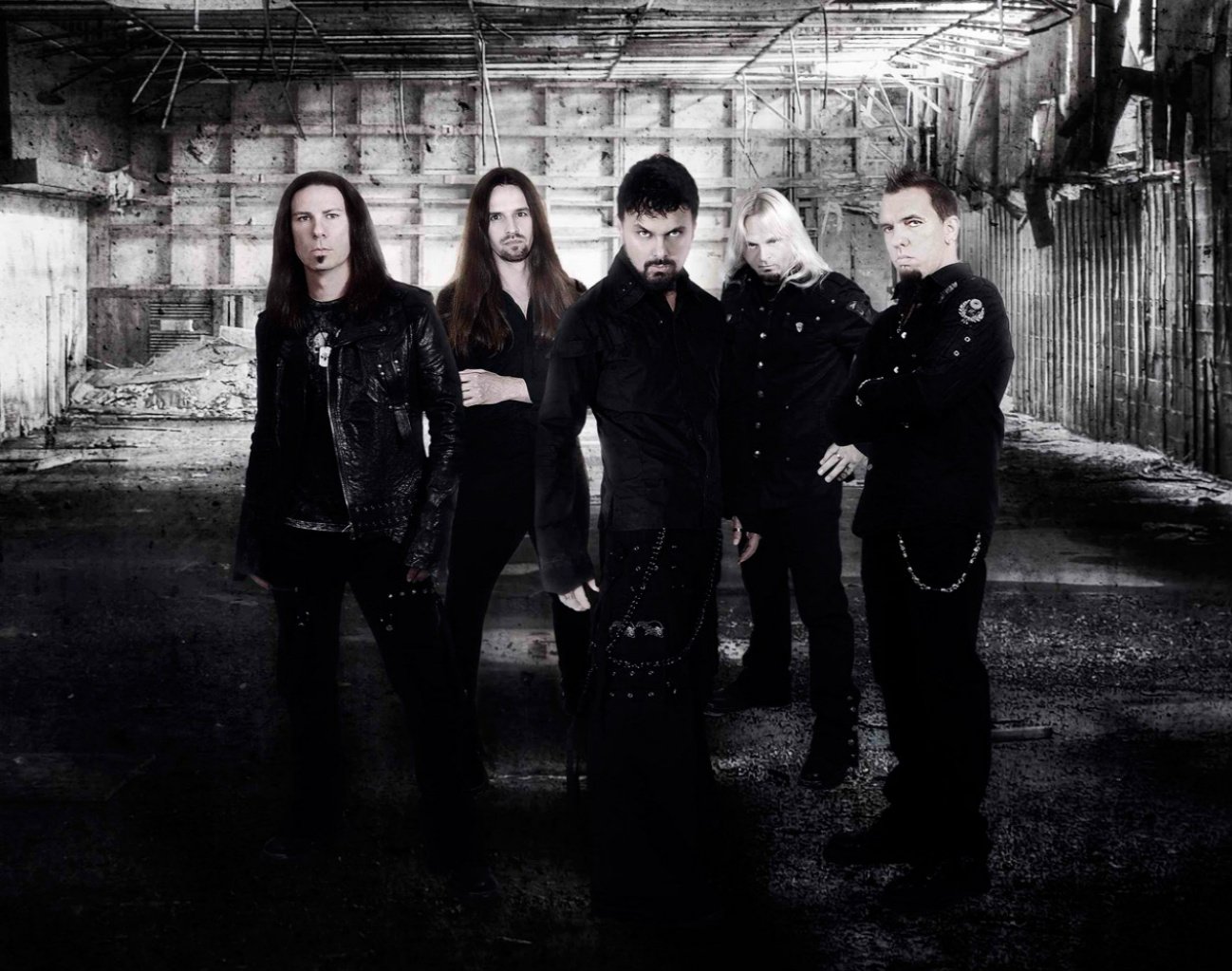 HD PC desktop wallpaper featuring the music band Kamelot standing in a dark, industrial setting with a dramatic and moody atmosphere.