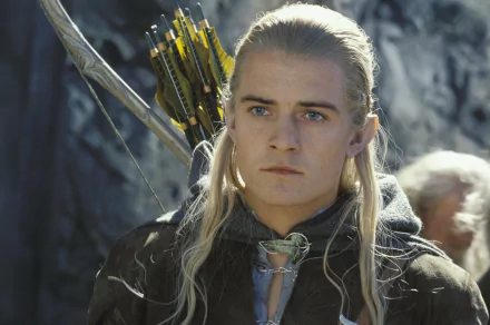 HD desktop wallpaper featuring Legolas from *The Lord of the Rings: The Two Towers*, showcasing his determined expression and iconic blonde hair, with his bow and arrows in the background.