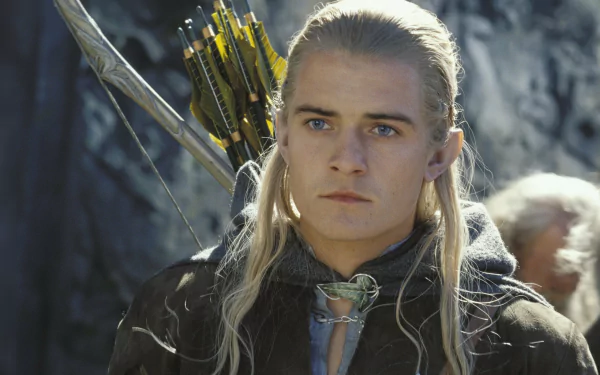 HD desktop wallpaper featuring Legolas from *The Lord of the Rings: The Two Towers*, showcasing his determined expression and iconic blonde hair, with his bow and arrows in the background.