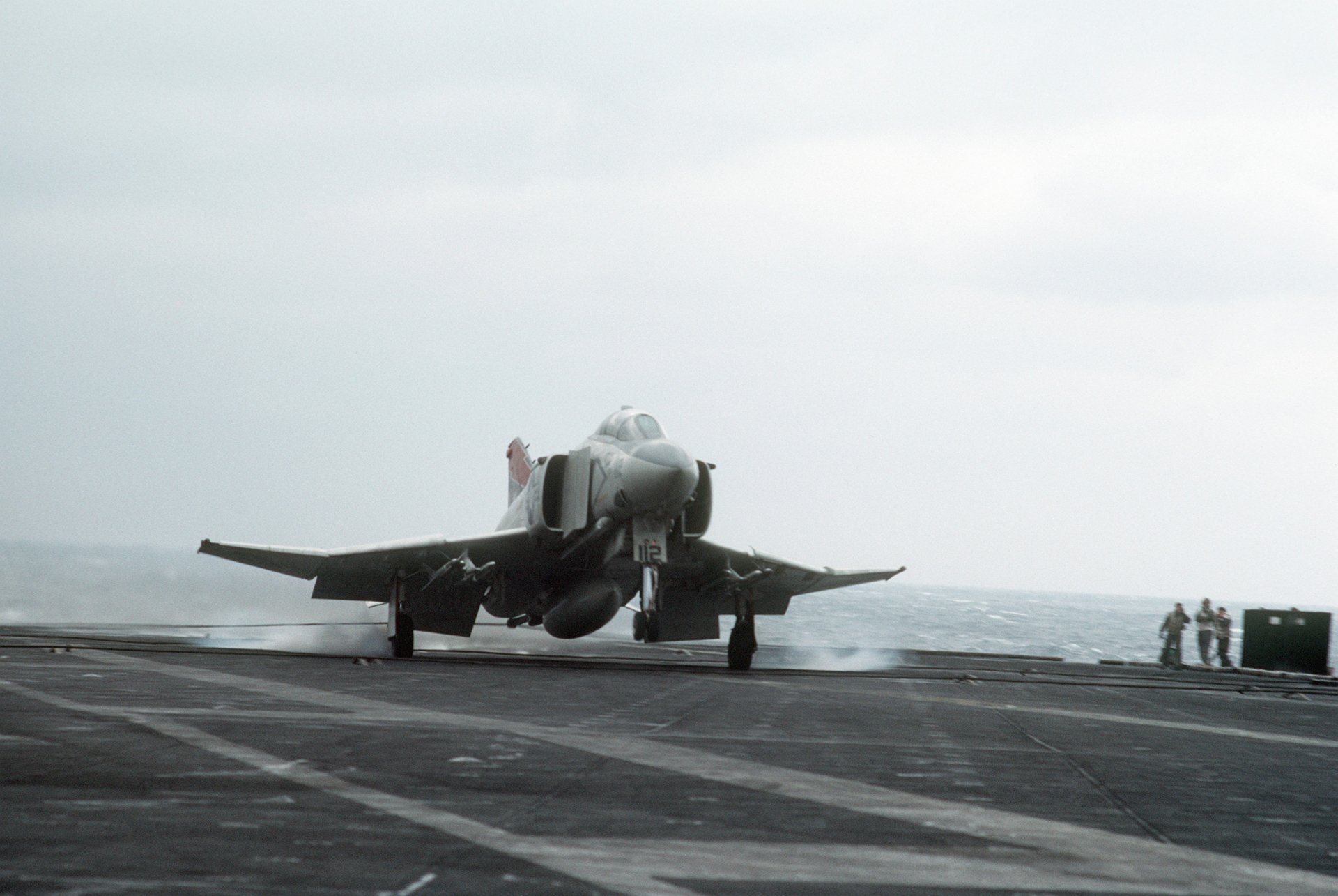 Military McDonnell Douglas F-4 Phantom II jet taking off from an aircraft carrier, captured in a high-definition PC desktop wallpaper and background.