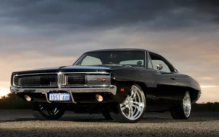 HD desktop wallpaper featuring a black Dodge Charger RT parked on a road with a dramatic cloudy sky backdrop.