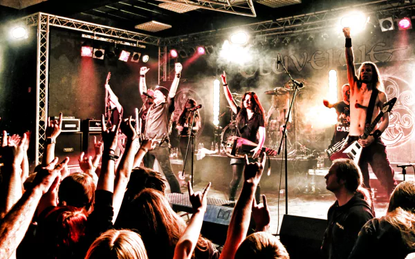 HD PC desktop wallpaper featuring Eluveitie performing live on stage with energetic lighting and an engaged crowd, capturing the intensity of their music.