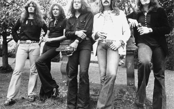 Black and white HD desktop wallpaper featuring the rock band Deep Purple posing outdoors among trees, capturing a classic music moment.