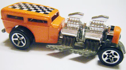 Close-up of a man-made orange Hot Wheels toy car with twin chrome engines and checkerboard roof on white 2K Quad HD PC desktop wallpaper/background.