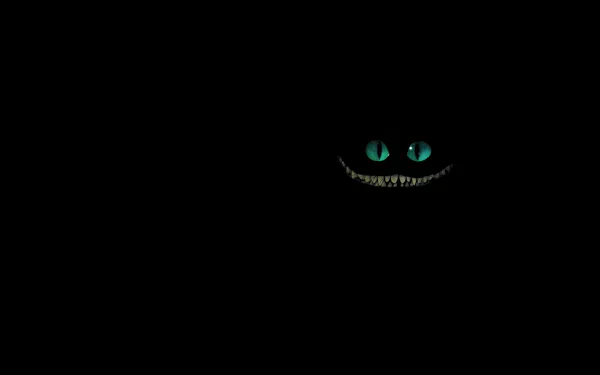 HD desktop wallpaper featuring the glowing eyes and wide smile of the Cheshire Cat from the 2010 movie Alice in Wonderland against a black background.