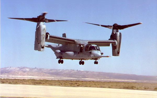 Military Bell Boeing V-22 Osprey aircraft flying low over a desert landscape, captured in a high-definition desktop wallpaper image.