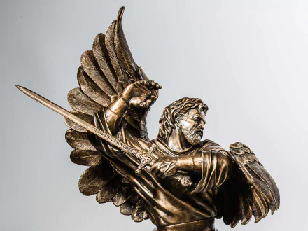 HD desktop wallpaper featuring a detailed man-made angel statue holding a spear with wings spread against a plain background.