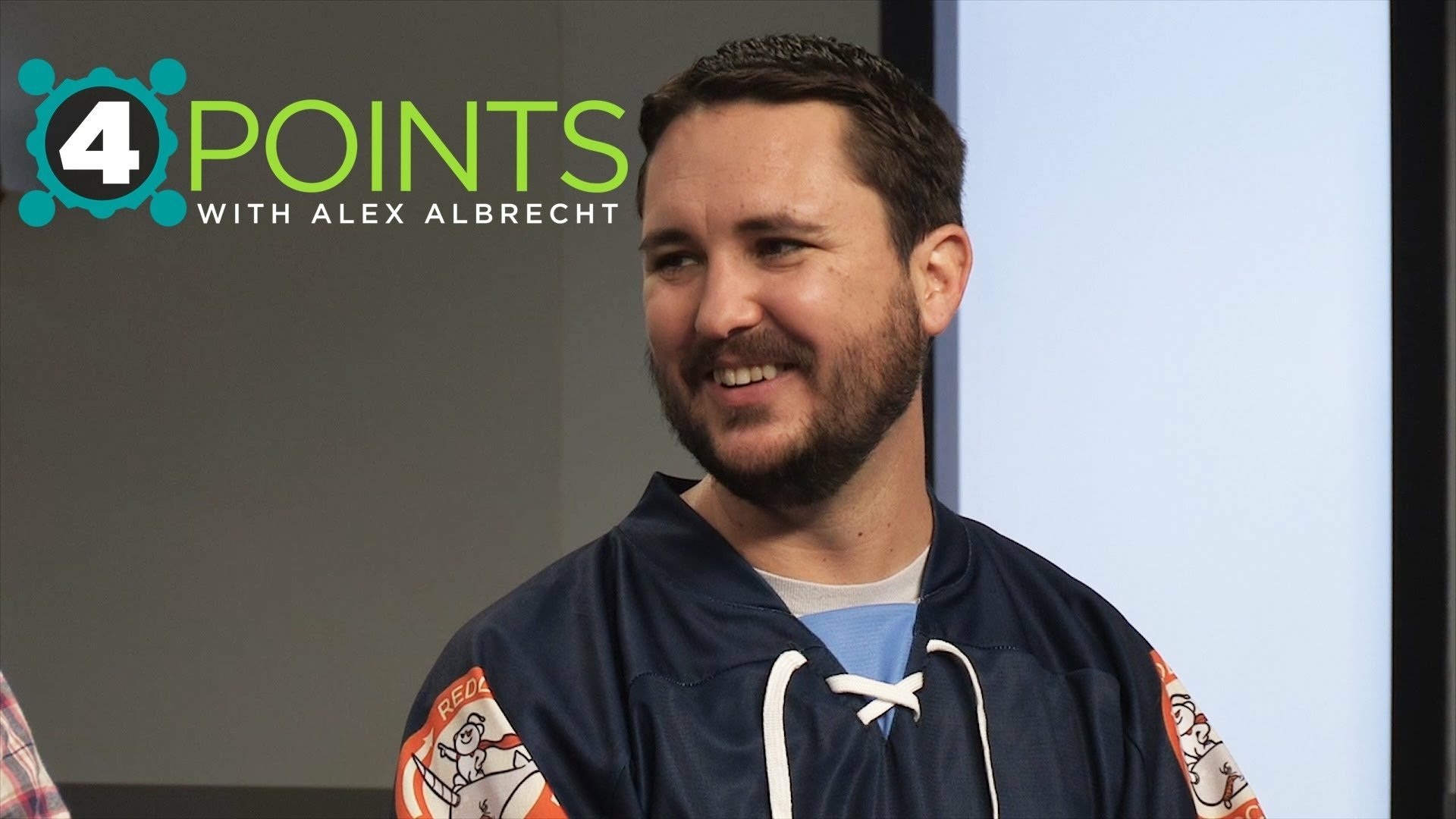 HD wallpaper featuring a man with a beard smiling, wearing a sports jersey, in front of a 4 Points with Alex Albrecht backdrop.
