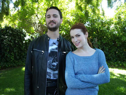 HD desktop wallpaper of two actors from The Guild, featuring Wil Wheaton and a female co-star standing outdoors.