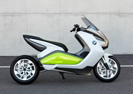 HD PC desktop wallpaper featuring a sleek BMW i electric scooter with a modern design in white and green against a plain concrete wall background.
