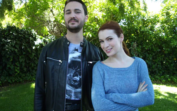 HD desktop wallpaper of two actors from The Guild, featuring Wil Wheaton and a female co-star standing outdoors.