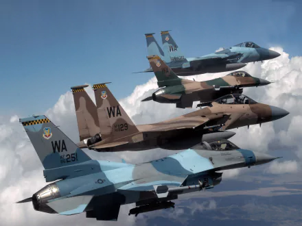 HD wallpaper featuring a McDonnell Douglas F-15 Eagle and a General Dynamics F-16 Fighting Falcon in flight against a cloudy sky.