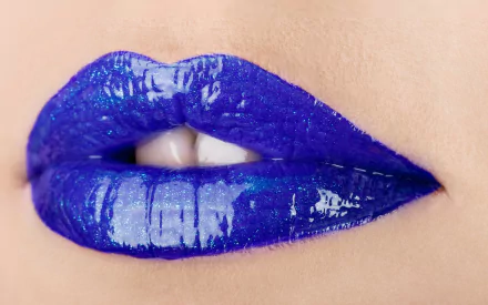Close-up of glossy, vibrant purple lips. This striking image serves as a bold and artistic HD desktop wallpaper, adding a unique touch to any background.