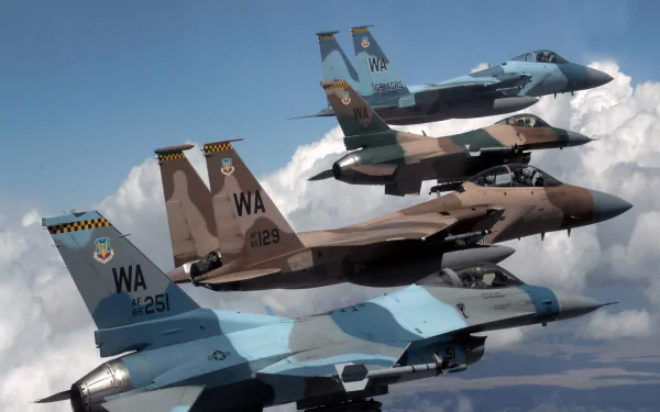 HD wallpaper featuring a McDonnell Douglas F-15 Eagle and a General Dynamics F-16 Fighting Falcon in flight against a cloudy sky.