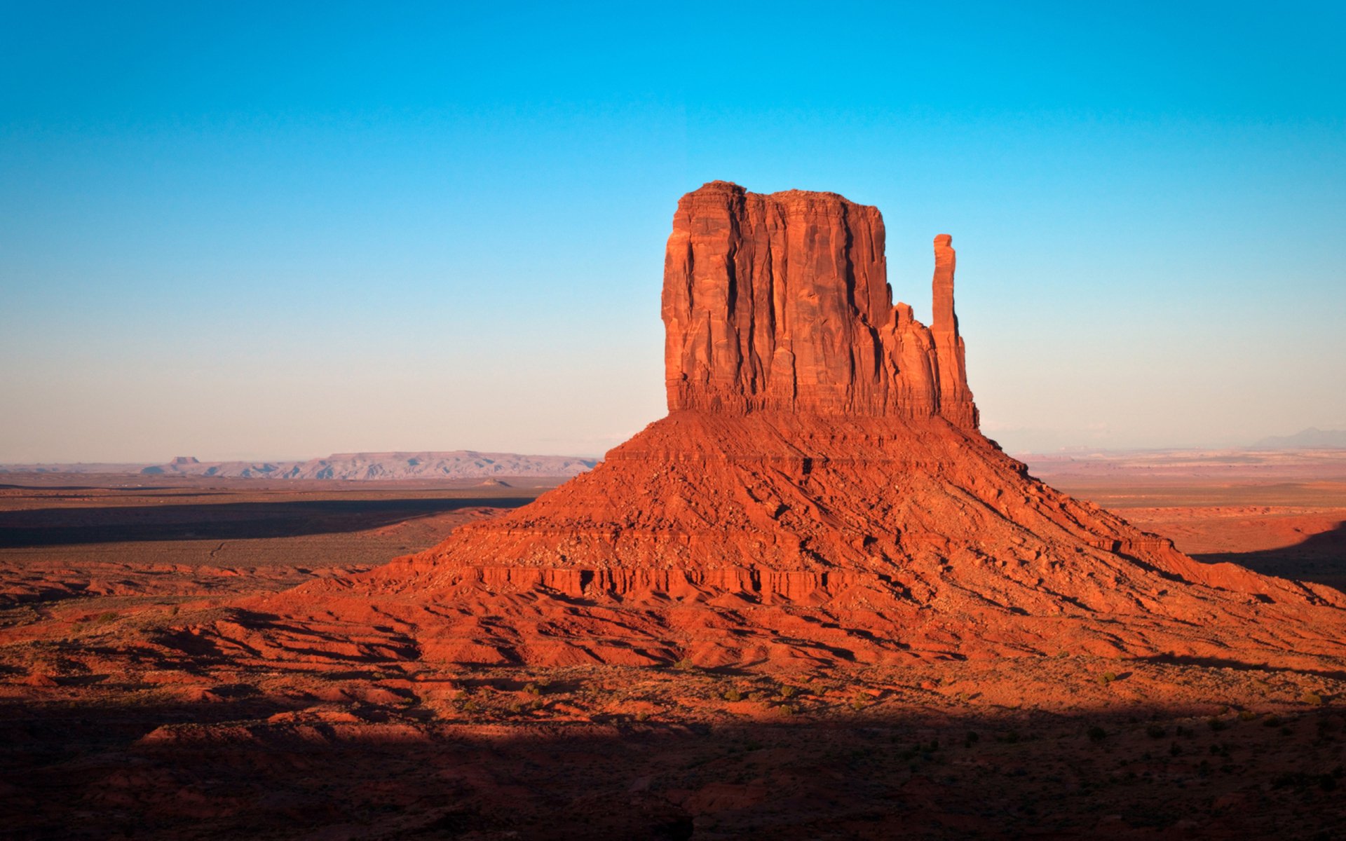 HD PC desktop wallpaper showcasing a striking red rock canyon formation under a clear blue sky in a natural landscape.