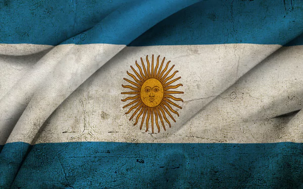 HD PC desktop wallpaper: textured, wrinkled flag of Argentina with blue-white-blue bands and a golden Sun of May centered, worn-grunge appearance.