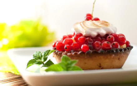 HD PC desktop wallpaper featuring a close-up of a sweet tart topped with red currants and cream, garnished with fresh mint leaves on a white plate.