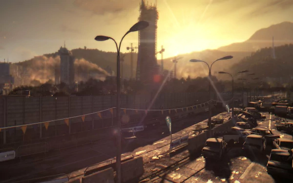 Dying Light video game HD PC desktop wallpaper: sunlit, post-apocalyptic cityscape with a crumbling tower, smoky skyline and a traffic-choked highway in the foreground.