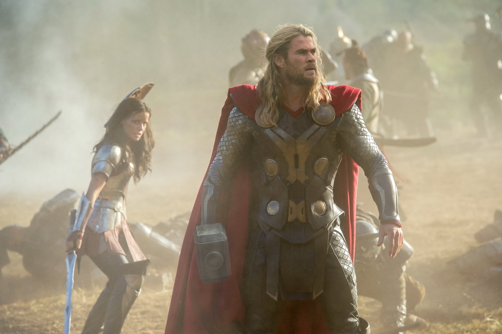 HD desktop wallpaper from the movie Thor: The Dark World featuring Chris Hemsworth as Thor in battle-ready armor with a red cape.