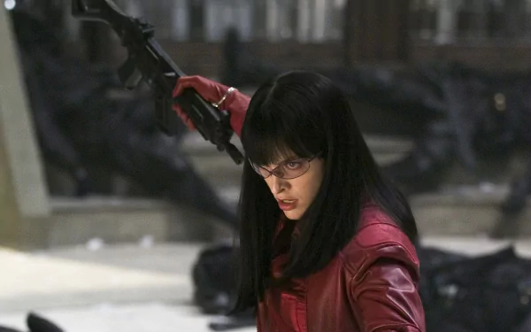 HD desktop wallpaper featuring Milla Jovovich in an action scene from the movie Ultraviolet, holding a weapon with a focused expression.