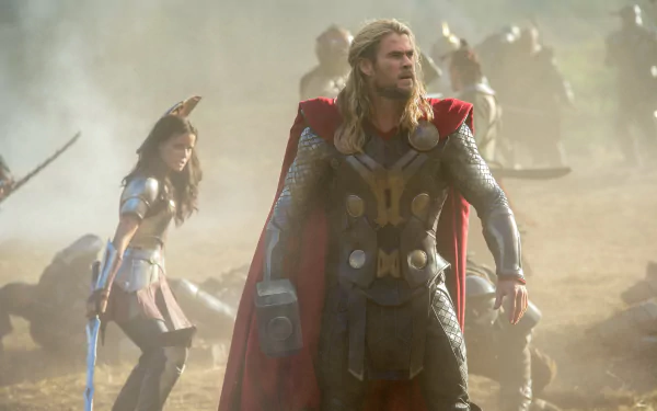 HD desktop wallpaper from the movie Thor: The Dark World featuring Chris Hemsworth as Thor in battle-ready armor with a red cape.