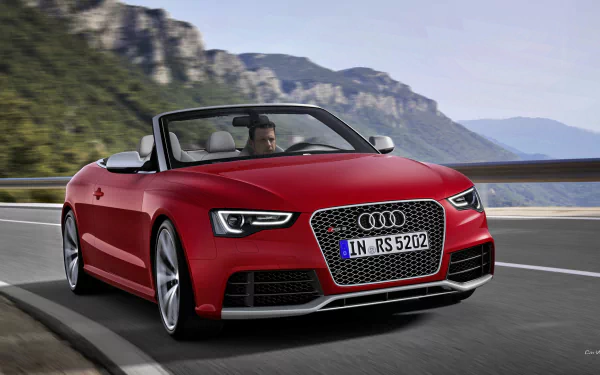 Red Audi RS5 convertible on a winding mountain road with cliffs and water in the background, presented as an HD PC desktop wallpaper and background.