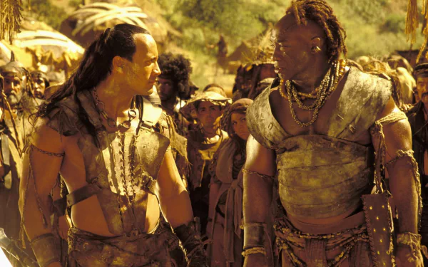 Dwayne Johnson and Michael Clarke Duncan face off in a scene from the movie The Scorpion King, featuring a rich backdrop of adventure and drama. HD wallpaper for fans of the film.