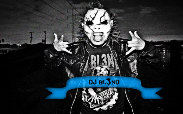 A striking black-and-white image of DJ BL3ND wearing a mask and metal spikes, embodying the energy of remix and electro house music, set against an urban backdrop.