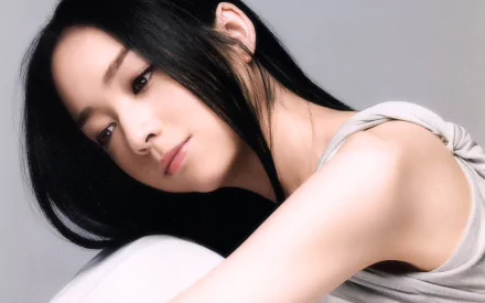 HD desktop wallpaper featuring Emiri Miyamoto. The image shows a woman with long, black hair and a serene expression, set against a neutral background.