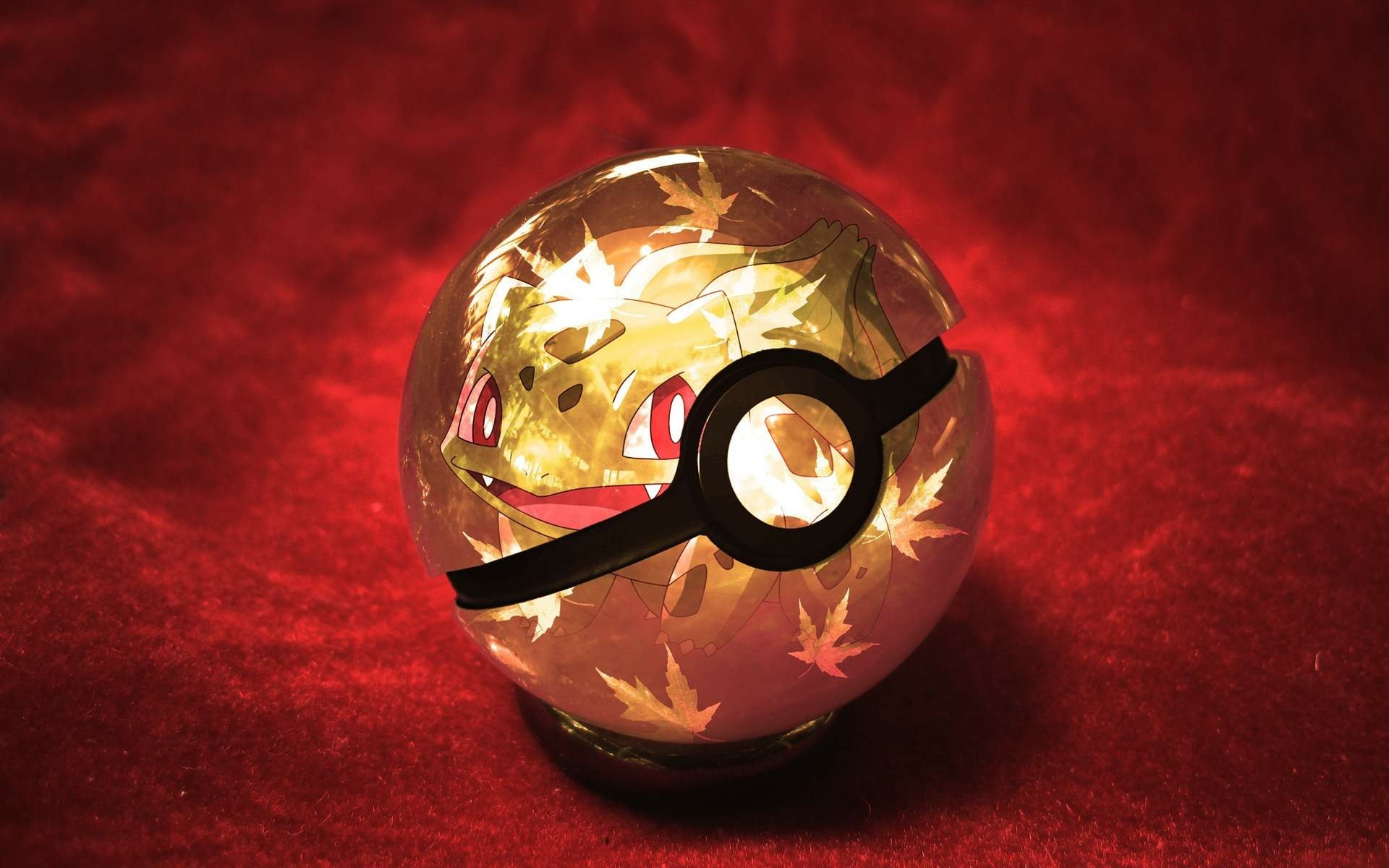 A vibrant HD wallpaper featuring a glowing Pokéball with a playful Pokémon inside, surrounded by artistic leaf patterns on a rich red background.