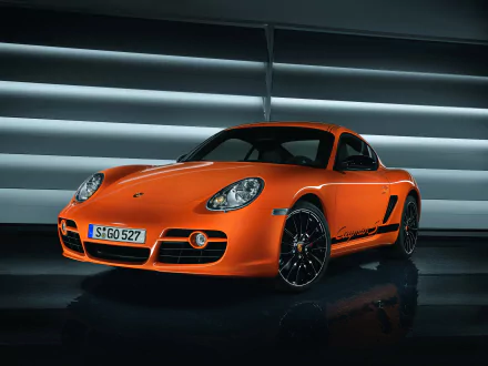 Orange Porsche Cayman S sports car displayed as a high-definition PC desktop wallpaper, highlighting sleek design and dynamic curves of the vehicle.