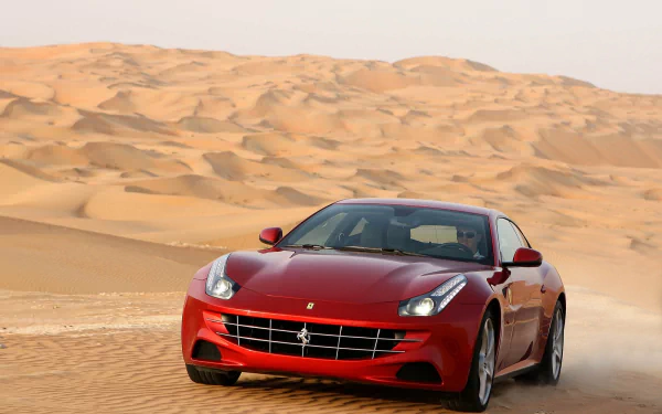 A red Ferrari FF driving through sand dunes, captured in a high-definition PC desktop wallpaper showcasing the vehicle’s sleek design against a desert backdrop.