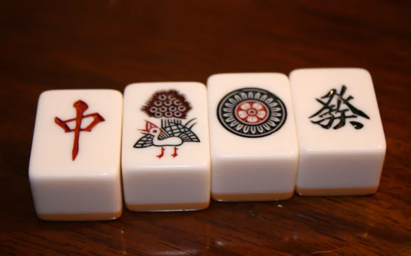 Man-made mahjong tiles close-up on a wooden table, detailed 4K Ultra HD PC desktop wallpaper and background.