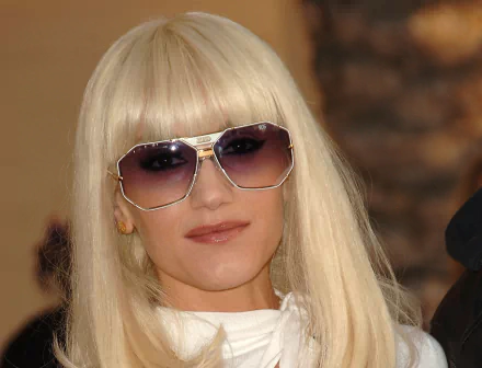 HD desktop wallpaper featuring Gwen Stefani with blonde hair and sunglasses, capturing her iconic music style.