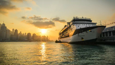 A stunning HD wallpaper featuring the Celebrity Millennium cruise ship docked at sunset, with a vibrant skyline in the background and shimmering waters.