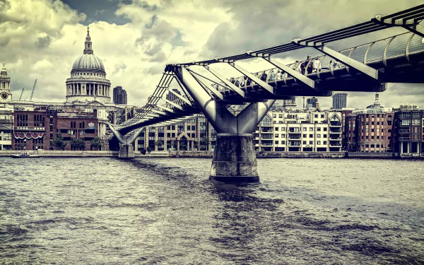 Man-made Millennium Bridge spans the Thames toward St. Paul's Cathedral under dramatic skies; 4K Ultra HD PC desktop wallpaper/background.