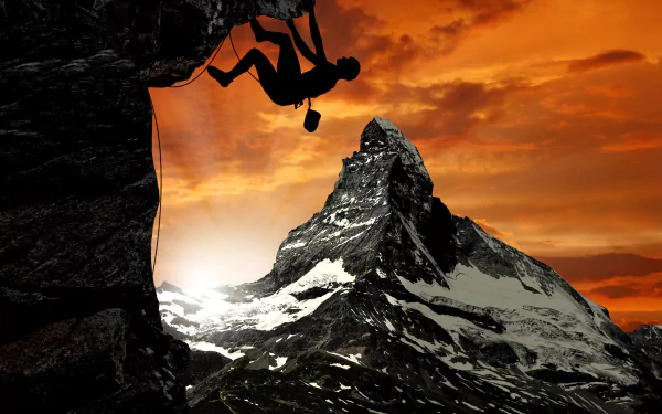 A climber dangles from a rocky cliff against a dramatic sunset, with a majestic mountain peak in the background. An inspiring scene celebrating climbing and adventure.