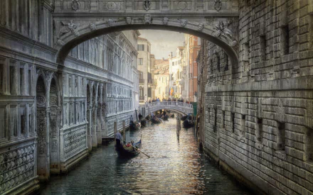 HD desktop wallpaper featuring the Bridge of Sighs, a famous man-made landmark in Venice, Italy, spanning a serene canal with gondolas passing beneath.