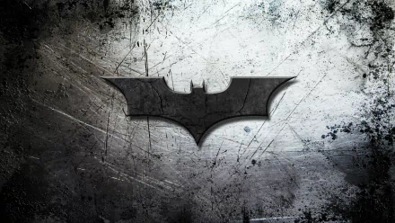 HD desktop wallpaper featuring the Batman symbol on a grungy, textured background. The iconic bat emblem is centered, creating a striking contrast against the distressed surface.